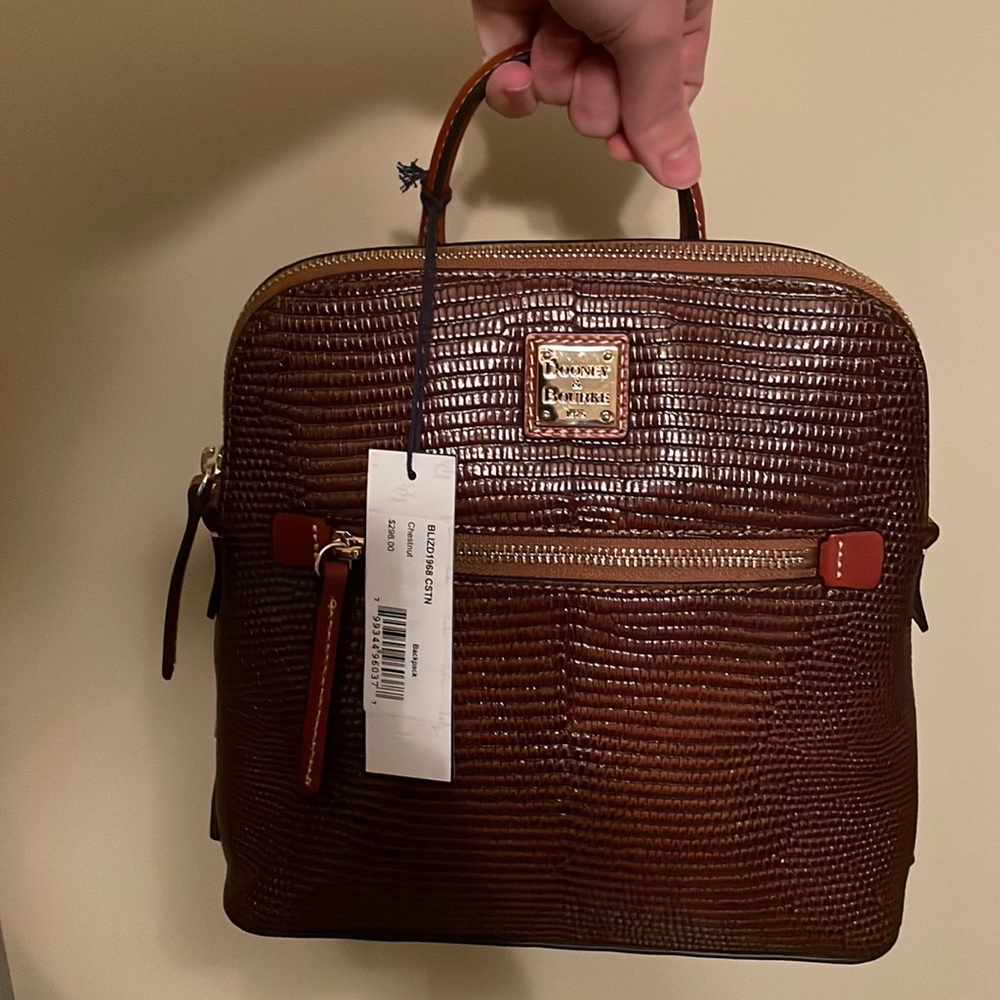 Moving and need space! Cute brown leather Dooney backpack. NWT from Dillards.